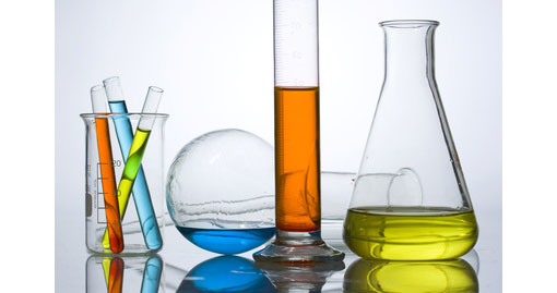 laboratory bottles containing different coloured liquids at varying levels