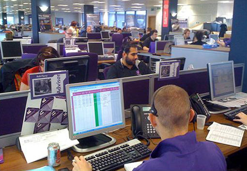 View of the British Gas call centre. Note the purple shirts and chairs as well as the personality type badge on the left.