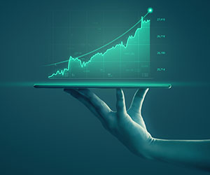 Hand holding tablet showing data 