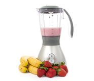 food blender with strawberries and bananas