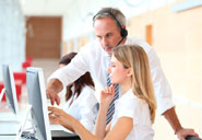 trainer wearing a headset teaching a young person