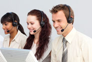 A photo showing a three people in a call centre