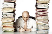 man swamped with paperwork and files