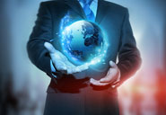 man in a business suite holding a globe