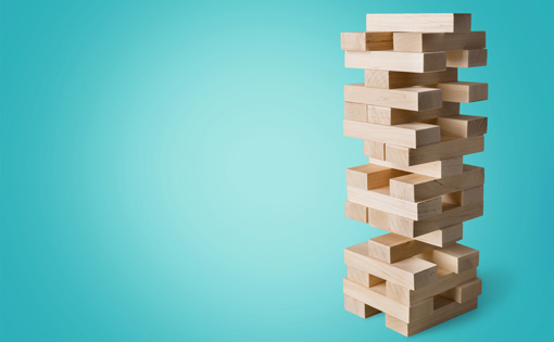 A tower of stacked building blocks like the game jenga