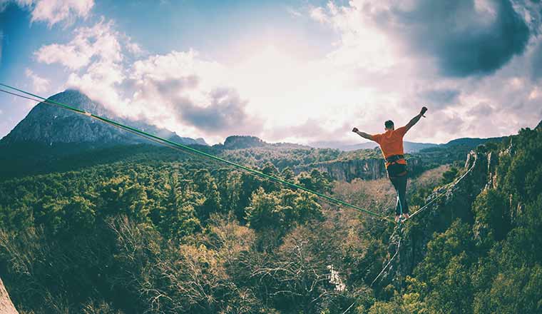 man walking on tightrope