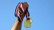 holding-up-medals