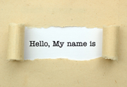 An envelope has been ripped open with the words 'Hello, My name is' typed behind the tear