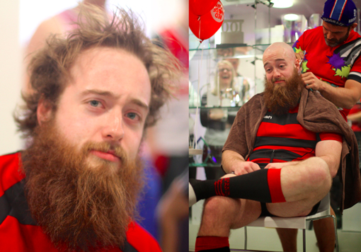 A man with long hair and a beard has his head shaved 