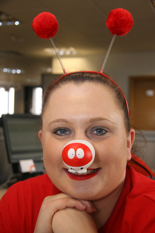 A woman with a red nose and a bobble headband