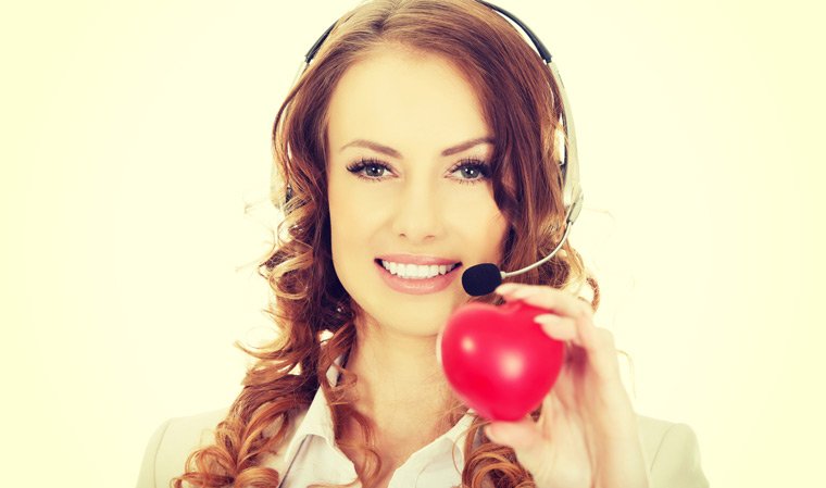 Call centre advisor holding a heart in front of her face