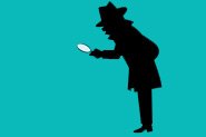 A silhouette of a man with a magnifying glass