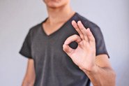 A person gives the okay sign