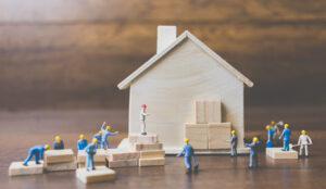 Small toy builders construct a house together.