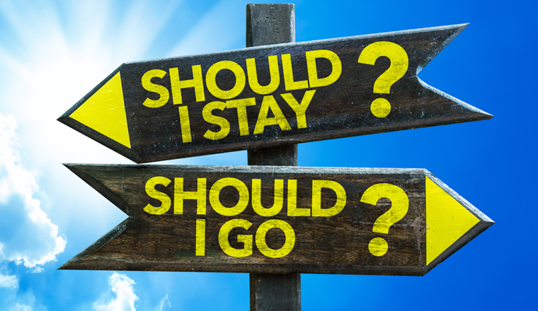 Two sign posts saying, should I stay or Should I go