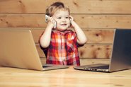 smiling-child-using-two-phones