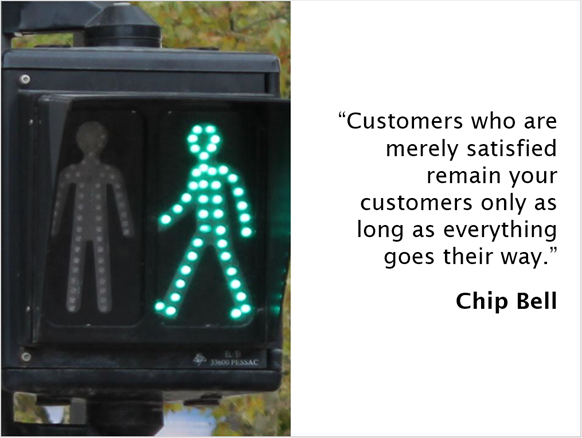 A crossing sign with the quote from Chip Bell: "Customers who are merely satisfied remain your customers only as long as everything goes their way".