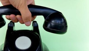 Hand hanging up the phone call closing spiel