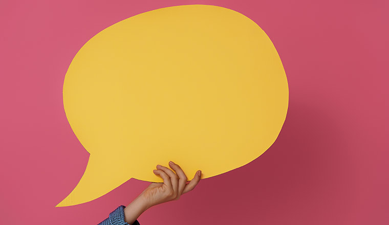 holding yellow speech bubble