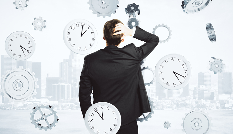 A man holding his head, looking at a cityscape, is surrounded by clocks and cogs falling from the sky