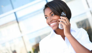 A business woman talking on a cell phone at office building