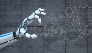 Hand of the robot with flat gears on the concrete background.