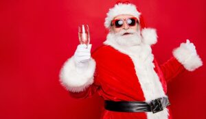 A chilled out santa holds up a glass of wine