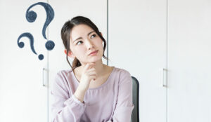 A woman looks puzzled, with question marks hovering over her head