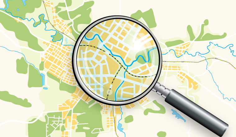 A magnifying glass zooms in on a map