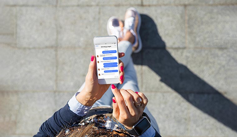 Woman using instant messaging app on mobile phone