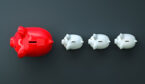 A large red piggy bank is followed by 3 smaller piggy banks