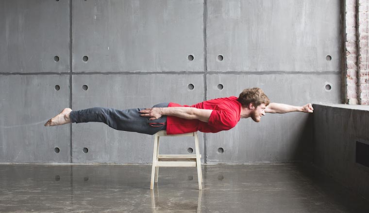 Man with a beard in the pose of a superhero