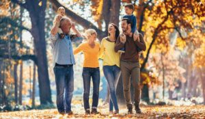 Multl generation family in autumn park having fun