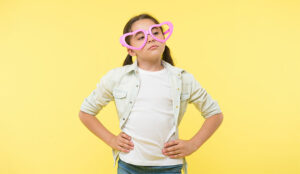 A photo of a child wearing love heart glasses