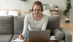 Focused female wear headset sit on couch