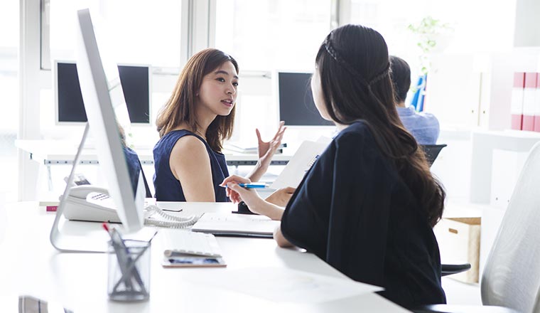 A photo of someone explaining something while sitting down