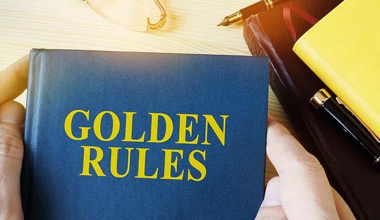 Man holding guide with title golden rules.