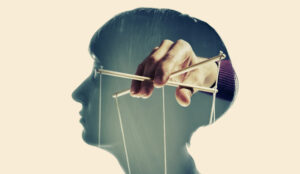 The strings of a puppet are being controlled by the mind of a woman