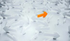 A picture of an orange arrow among white arrows