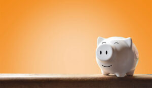 A happy looking money bank shaped like a pig