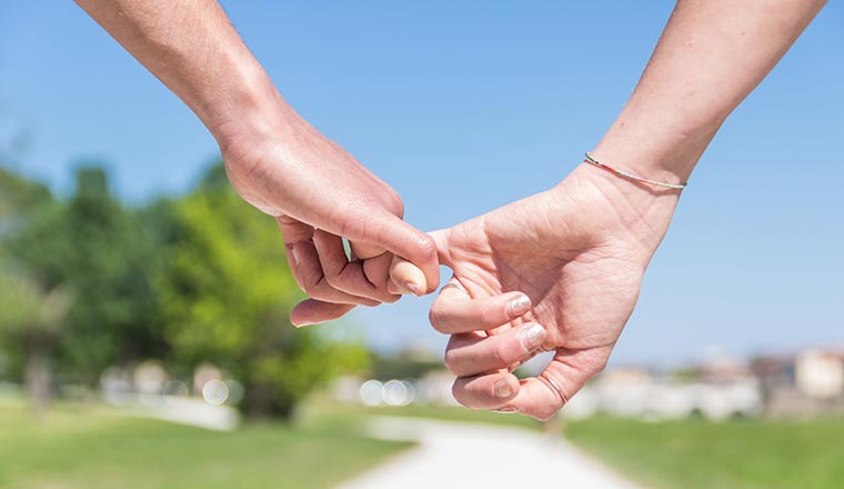 Close up hands making a pinkie for trust ,swear and promise.