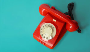 Beautiful red vintage phone on a blue background