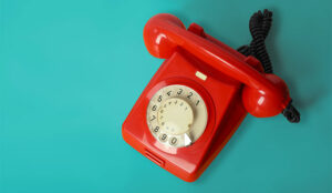 Beautiful red vintage phone on a blue background