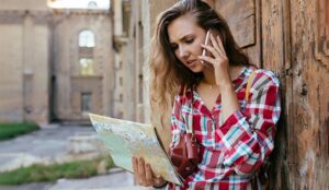 A photo of a frustrated looking woman holding a map