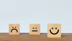 Smiley face wood cube on white background.