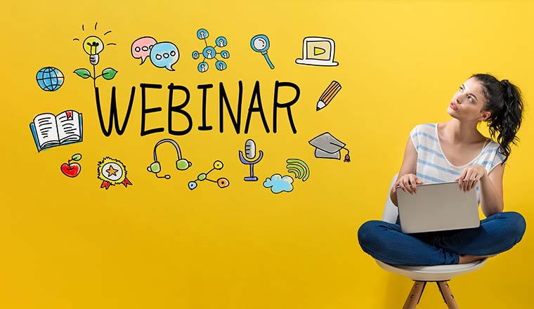 A woman sits on a chair and looks at the work webinar