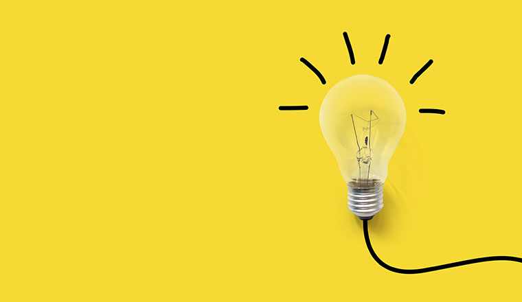 A picture of a light bulb on yellow background