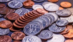 A photo of American coins and us dollars on a black table