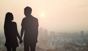 A photo of two silhouettes holding hands