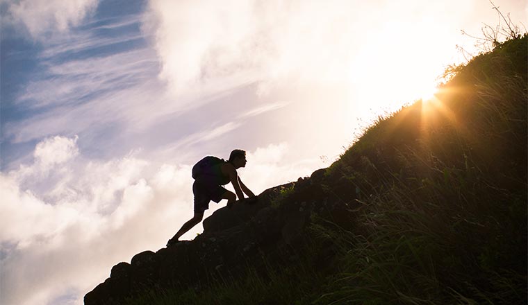 A picture of a person climbing up a hill